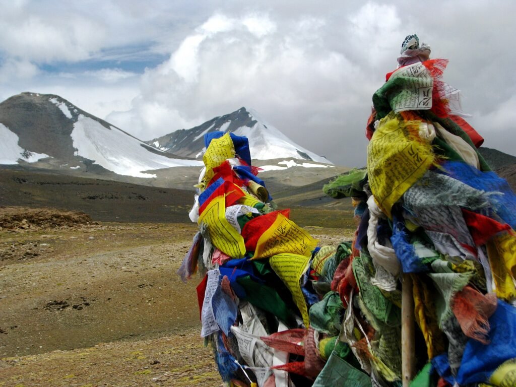 Prayer flags and glaciers on a high pass in Ladakh